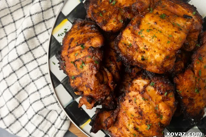 Perfect Pellet Grilled Chicken Thighs 5 Assortment of raw boneless, skinless chicken thighs seasoned with a dry rub and ready for the Bang Bang sauce application.