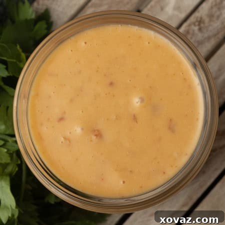 Bang Bang Sauce in a glass jar with a fresh garnish