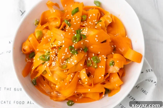 Vibrant carrot ribbon salad in a white bowl, ready to be served