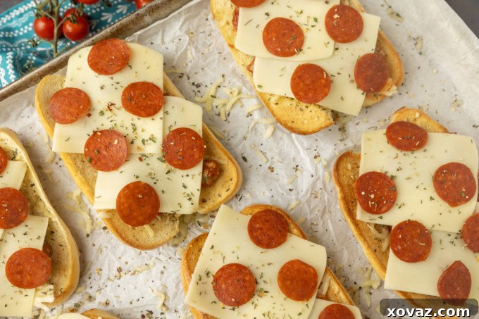 Pizzawich 4 pizza sub sandwiches on parchment on a pan