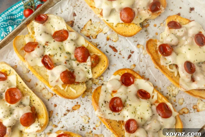 Pizzawich 5 toasted pizza sub sandwiches on parchment on a pan