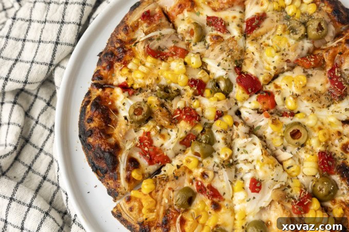 Delicious European Tuna Pizza topped with savory tuna, fresh onions, and roasted red peppers.