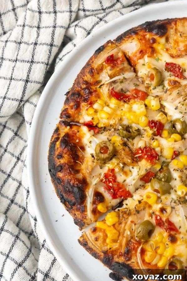 A freshly baked European tuna pizza, sliced and ready to serve