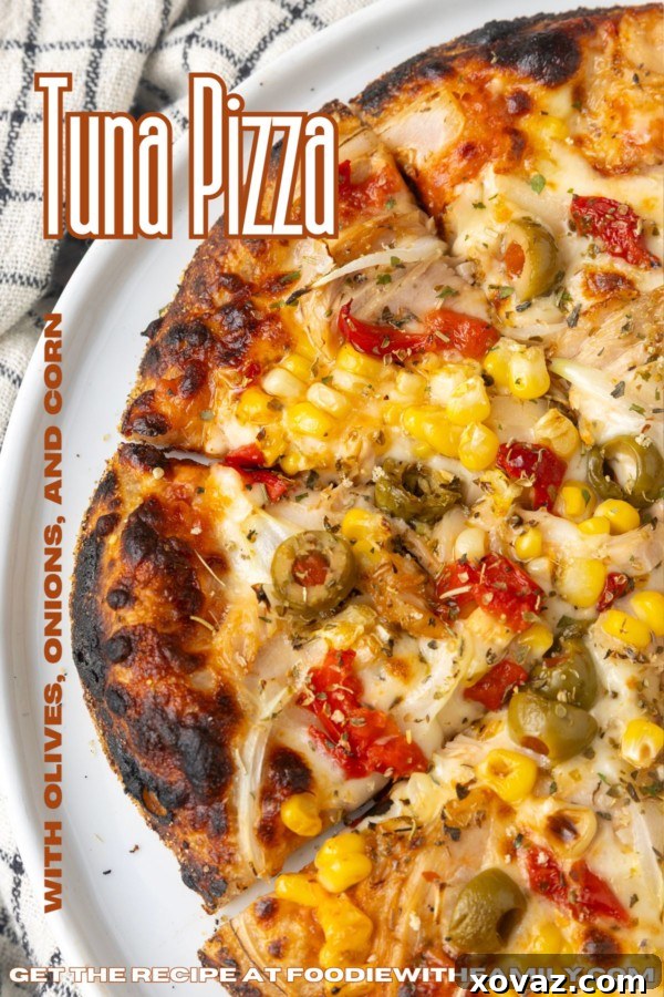 Overhead shot of a full tuna pizza with all toppings, ready to eat