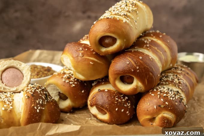 Pretzel Pup 2 pretzel dogs on parchment paper on a pan with a variety of dips