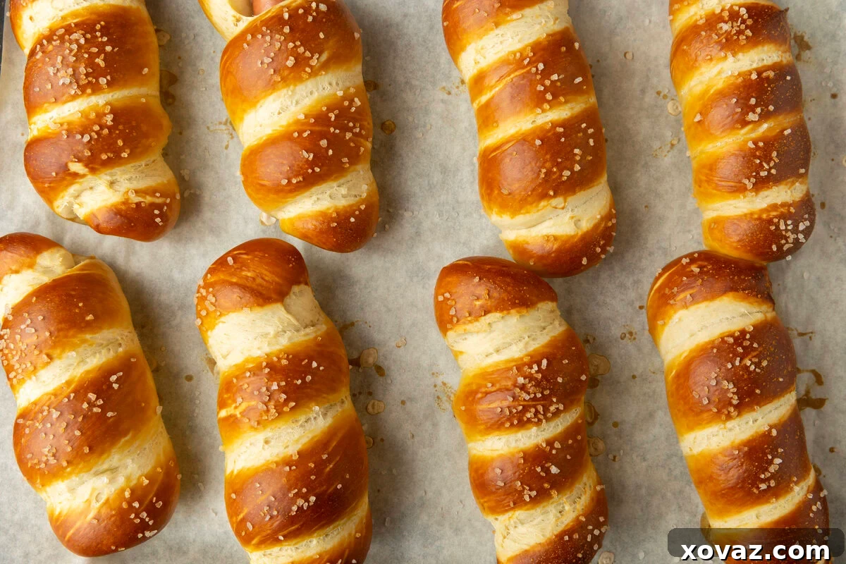 Pretzel Pup 3 pretzel dogs on parchment paper on a pan