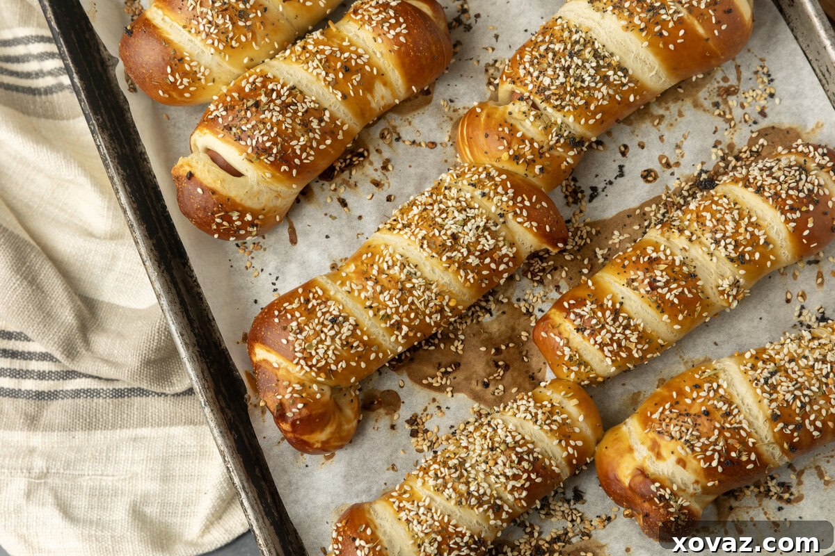 Pretzel Pup 4 pretzel dogs on parchment paper on a pan