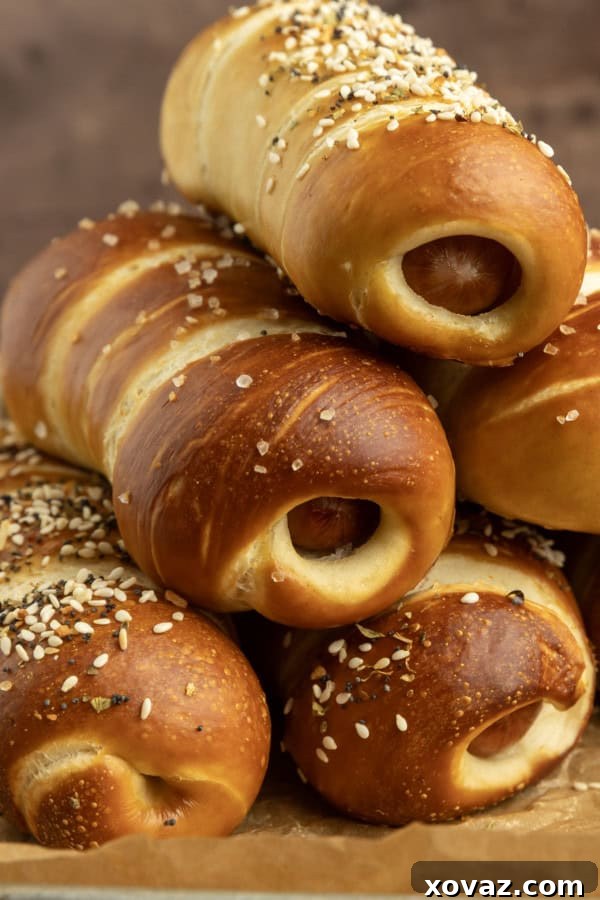 Pretzel Pup 5 pretzel dogs on parchment paper on a pan with a variety of dips