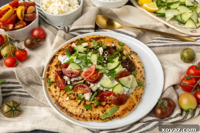 Pita bread being pressed onto seasoned ground lamb on a hot griddle.