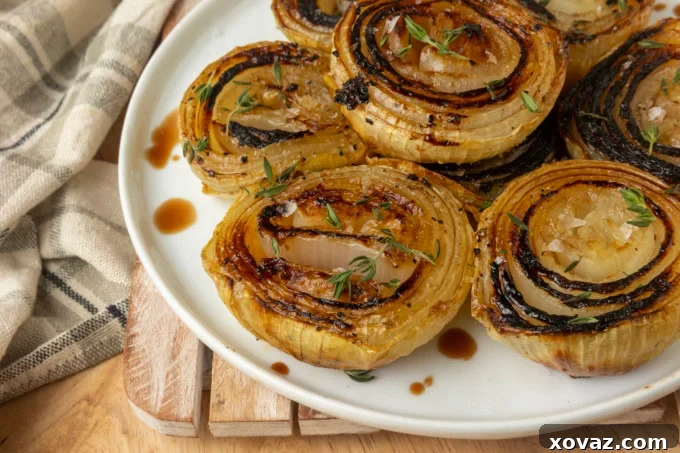 Golden brown baked onion halves on a rustic plate, ready to be served.
