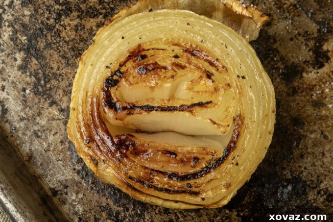 Onion halves arranged on a sheet pan before baking.