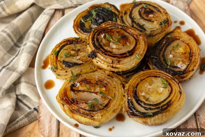 Close-up of a rustic plate filled with golden, tender baked onion halves.