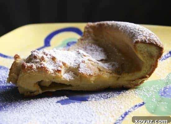 Close-up of Pannukakku batter being poured into a hot, buttered pan, ready for baking in the oven.