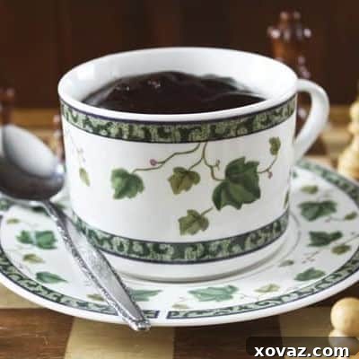 Thick and creamy Spanish style hot chocolate in a mug, garnished with chocolate shavings.