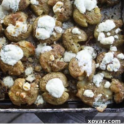 Close-up of Crash Hot Potatoes with Gorgonzola cheese, showing crispy edges and melted cheese.