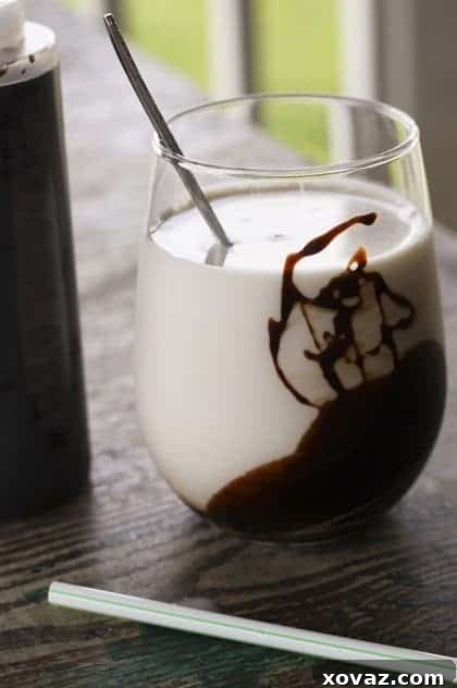 A jar of freshly made homemade chocolate syrup, rich and dark, ready for any sweet application.