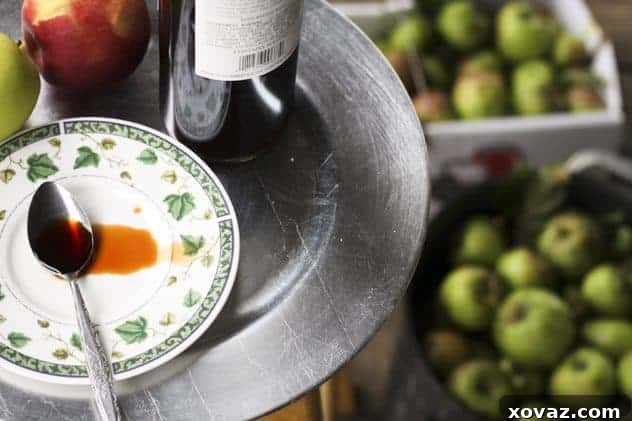 Storing Homemade Apple Molasses Freshly boiled cider being poured into a clean glass jar for storage