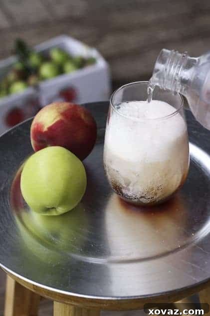 The Golden Hue of Apple Molasses Close-up of boiled cider syrup being poured into a small glass
