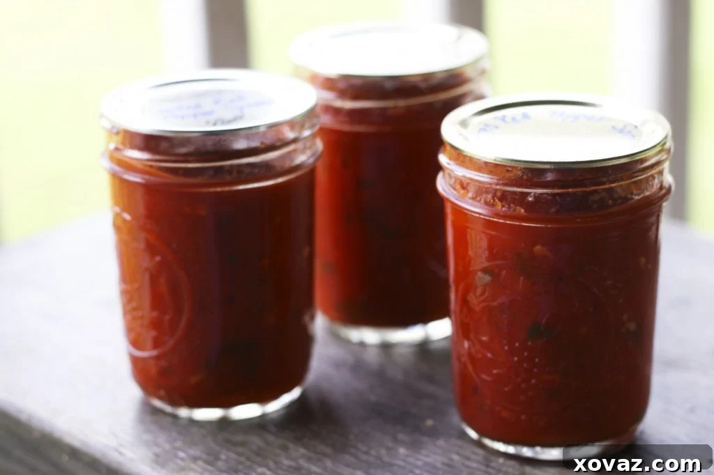 Three jars of homemade roasted red pepper spread, ready for gifting or storage.