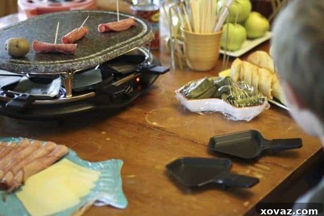 Raclette party setup with melted cheese and fresh ingredients