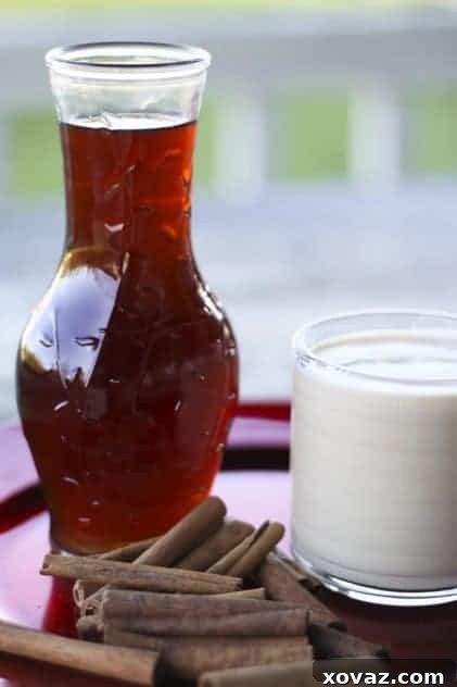 A soothing mug of homemade spiced orange chai concentrate with floating spices.