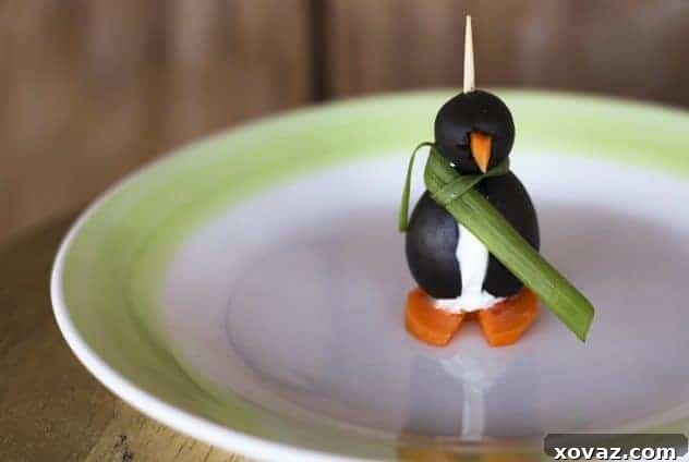 Close-up of a sharp Togiharu Gyotou kitchen knife cleanly slicing through a carrot, with blurred black olive penguins in the background, illustrating the importance of precise cuts in cooking.
