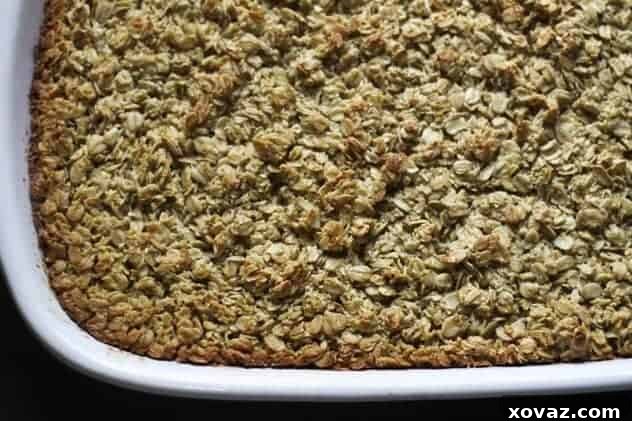 Baked oatmeal cooking in a baking dish, golden brown and bubbly