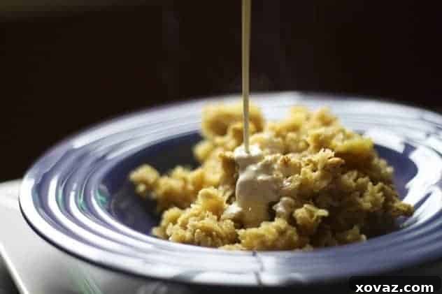 Close-up of baked oatmeal with a drizzle of heavy cream, ready to eat