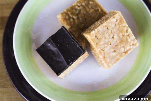 Finished Peanutty Crispy Bars, some covered in dark chocolate, ready to be enjoyed.