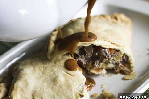 A delicious pasty, sliced open, ready to be enjoyed.