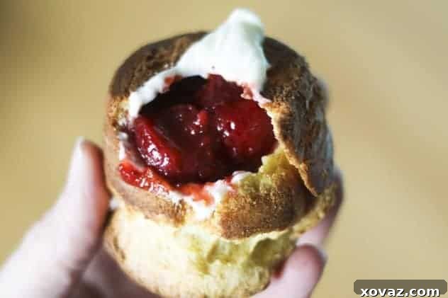 A whole wheat popover generously filled with Greek yogurt creme and strawberries.