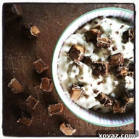 Rich Butterscotch and Milky Way Tapioca Pudding in a serving bowl, garnished with whipped cream and chocolate shavings.
