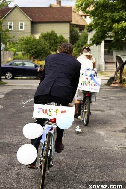 The newlywed couple, Luke and Elvi, riding away on decorated bicycles after their wedding.