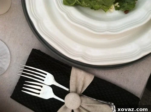 An inviting spread of gourmet appetizers A beautifully set table with a gourmet spread of appetizers and creative napkin swags at a food blogger dinner