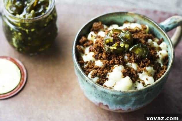 Taco Mac Hack for One-Pot Creamy Shells and Cheese Delicious one-pot creamy shells and cheese topped with seasoned taco meat and candied jalapeños, ready to be served.