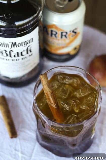 Dark 'n Stormy Orchard cocktail with apple slices and cinnamon sticks