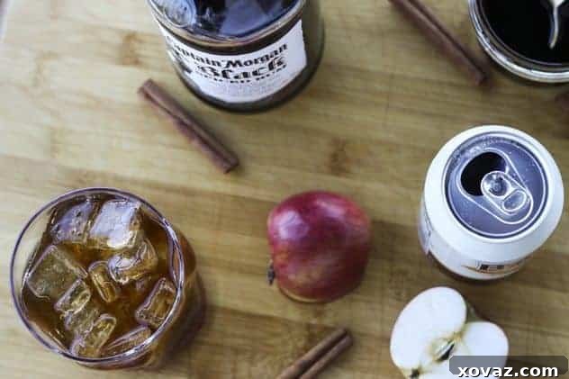 Dark and Stormy Orchard cocktail with ingredients on a wooden board